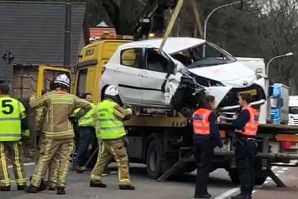 De takeldienst haalt het wrak op aan de Tilburgseweg in Poppel.