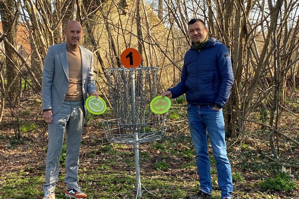 Mayor Peter Gisbrechts and Alderman of Sport Geron de Kuiper at one of the metal 'holes' on the disc golf course. 