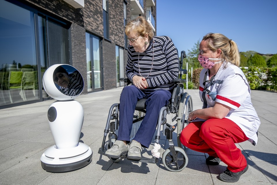 Bewoonster Marie Janssens (83) legt contact met robot James, met de hulp van huisverantwoordelijke Emy Reniers. 