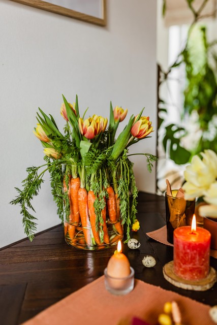 The Easter bunny eye wants something, too: Add playful accents, like these carrots in a flower vase. 