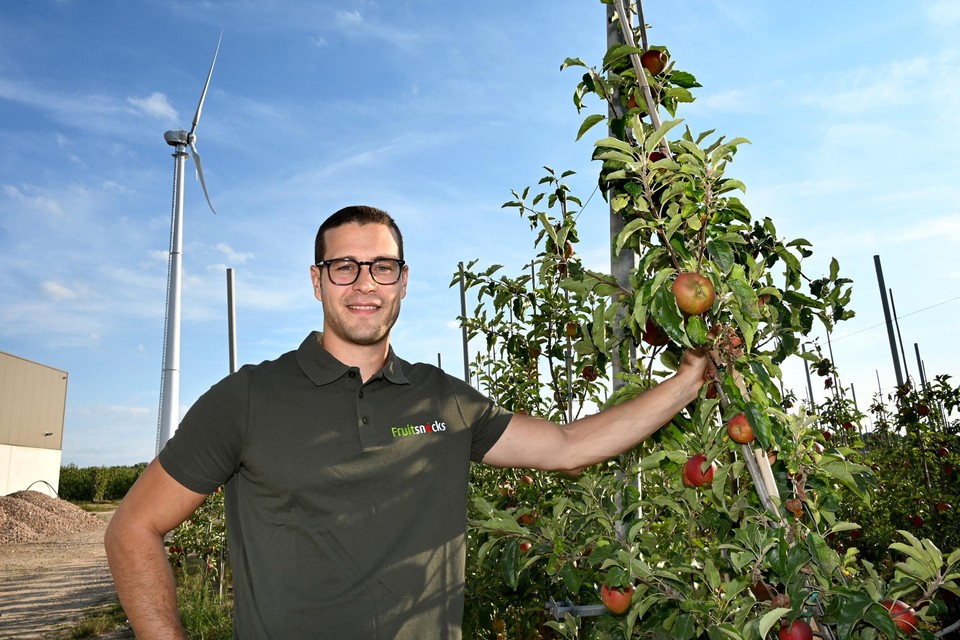 Roel Paesmans van Fruitsnacks met op de achtergrond de windturbine die het bedrijf in april liet plaatsen. “Je merkt dat er veel interesse is van andere bedrijven.” 