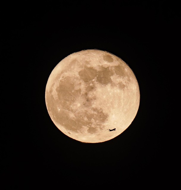 The plane seems to be flying past the moon.