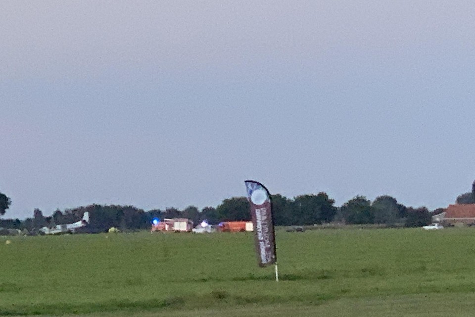 Het vliegtuig (links) belandde net naast de landingsbaan. 