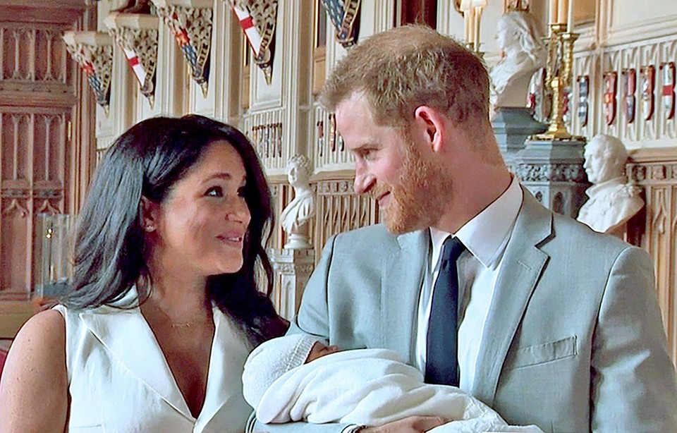 Prins Harry en Meghan Markle met hun zoontje Archie, die koningin al ontmoette twee dagen na de geboorte. 